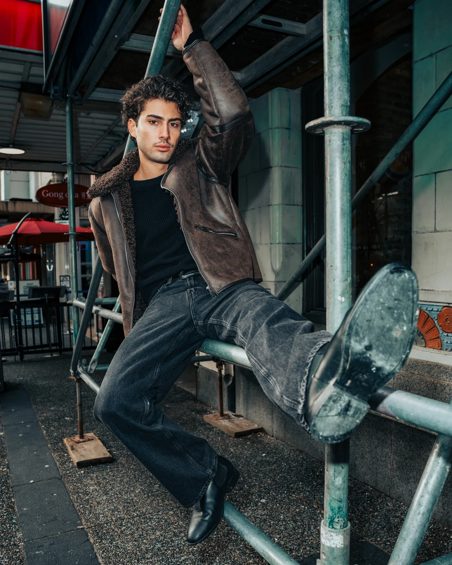 Urban editorial frame featuring model Mario on city street