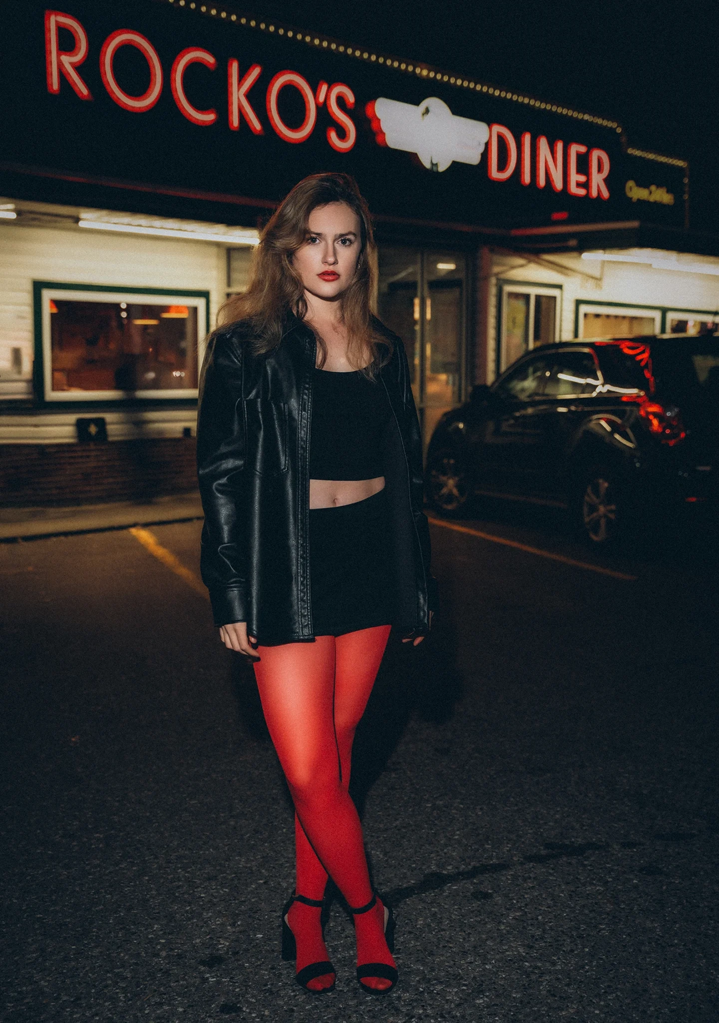 Cinematic fashion portrait of Lizzie in diner interior