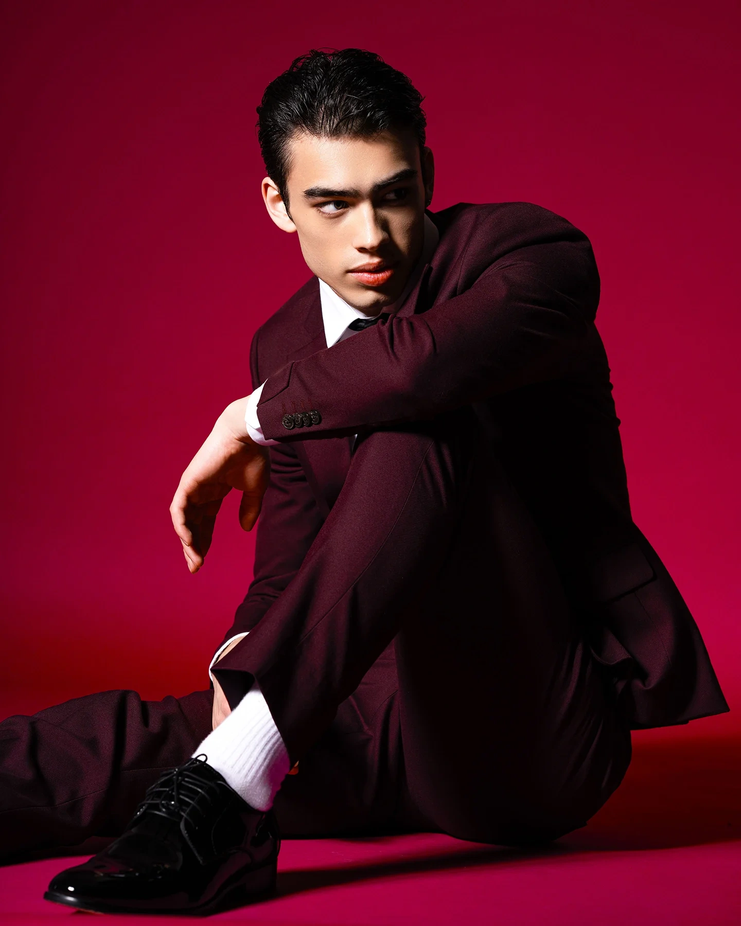 Tenet editorial cover portrait with red background and suit