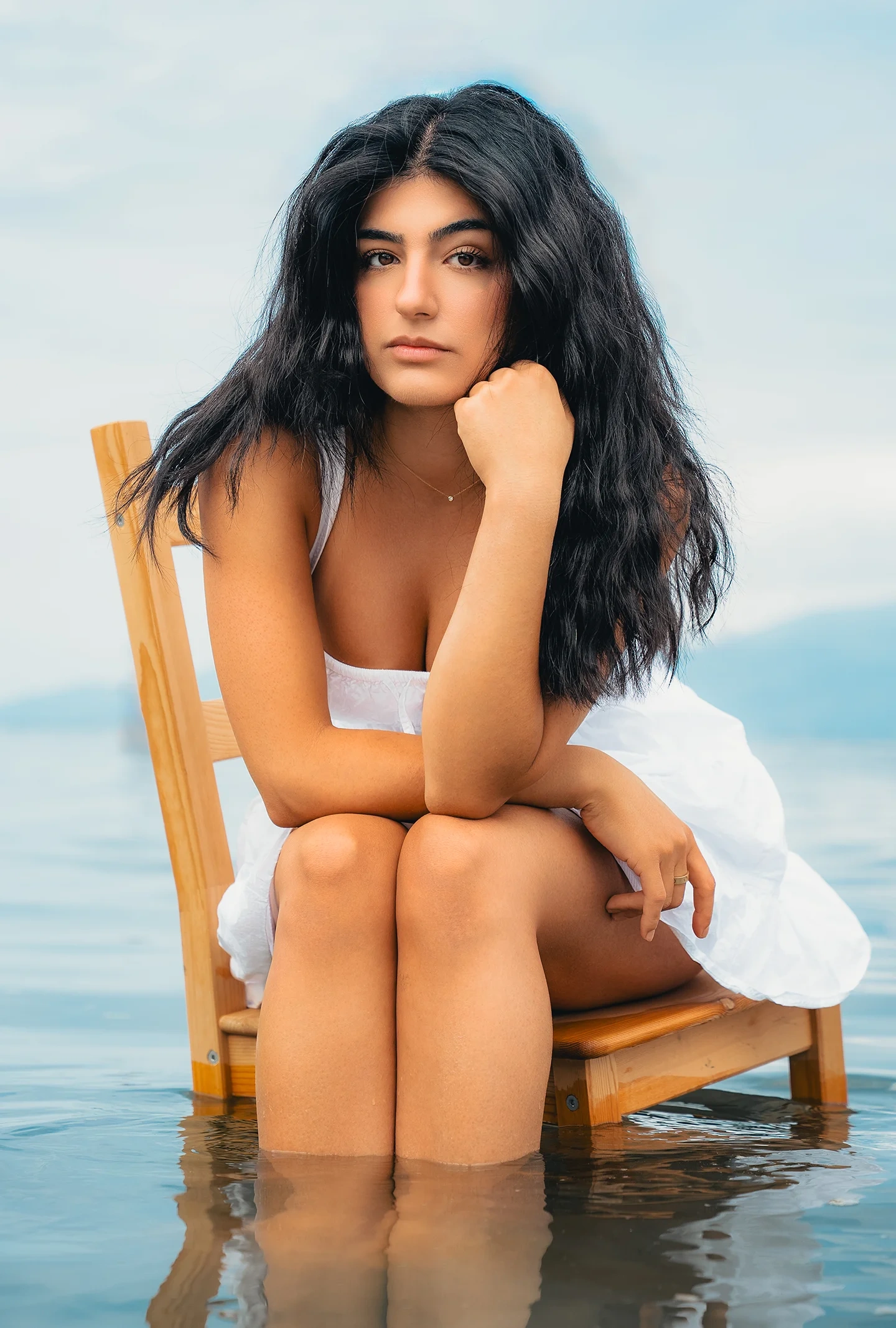 Fashion portrait of model Tina in the ocean wearing a white dress